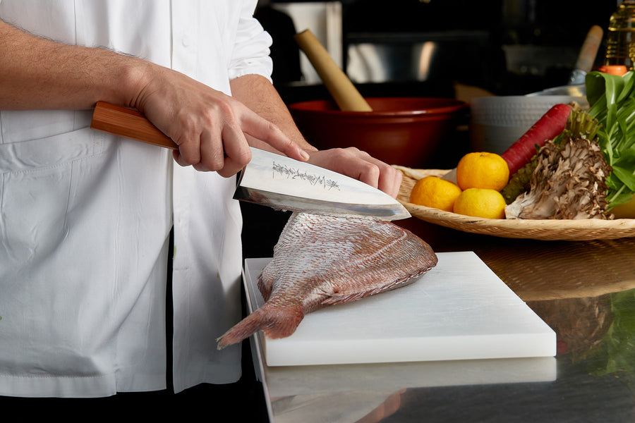 A photo of Gyuto knife being used.