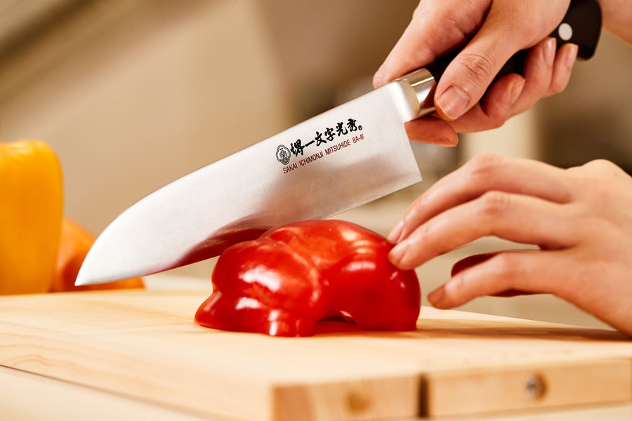 A photo of Santoku knife being used.