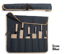 Load image into Gallery viewer, An iron-blue canvas roll holding a collection of Japanese knives.
