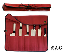 Load image into Gallery viewer, A red canvas knife roll shown in two states: rolled up and secured with a leather tie, and laid open to display six Japanese knives with wooden sheaths (saya).
